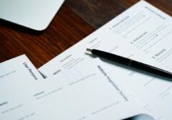 a pen sitting on top of a pile of papers