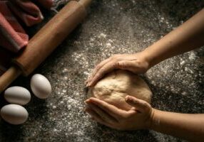 hands holding a pile of dirt